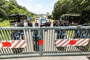 Riot policemen stand at the entrance of the Kourou space center (Centre Spatial Guyanais) during a protest over security and the state of the economy on April 4, 2017 in Kourou, French Guiana. A protest was held at the space centre on April 4 after French Prime Minister Bernard Cazeneuve rebuffed demands for 2.5 billion euros ($2.7 billion) of immediate funding for French Guiana, offering one billion euros instead. / AFP PHOTO / jody amiet
